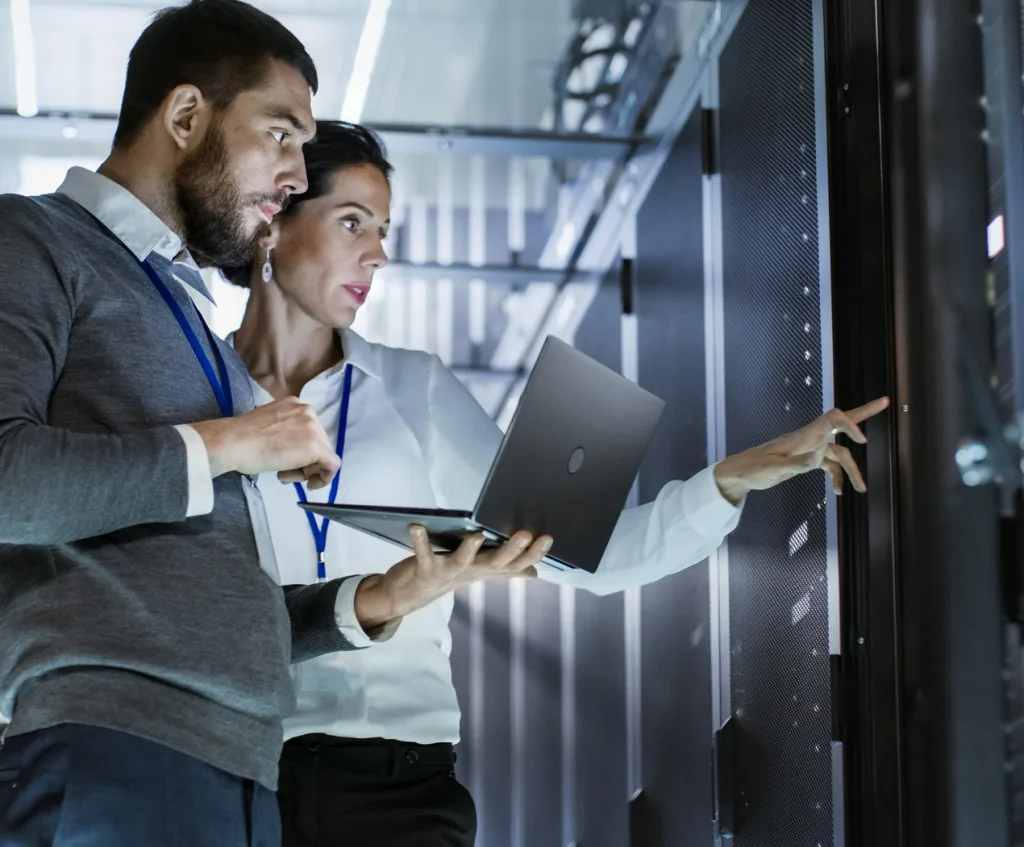 two people working on computer servers